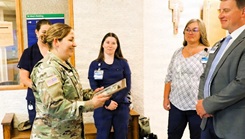 Fort McCoy Garrison Commander Col. Sheyla Baez Ramirez presents staff at the Mayo Clinic Health System medical facility