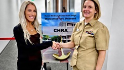 Capt. Jodi Phillips, Naval Medical Center San Diego (NMCSD) director of resource management, congratulates Brittany Fuller, a psychiatric certified nursing assistant, after Fuller received a tentative job offer at a civilian hiring event 