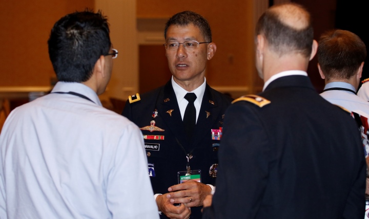 Army Maj. Gen. Joseph Caravalho, Jr., Joint Staff Surgeon (center), chats with attendees of the Military Health System Research Symposium (MHSRS) just before giving the opening remarks for the final day of the conference, Aug. 18, in Orlando, Florida. 
