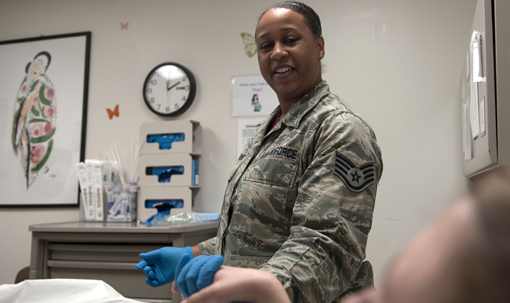 Air Force Staff Sgt. Ashley Williams, the 633rd Surgical Squadron women’s health NCO, assists a patient during a routine Pap test at Langley Air Force Base, Virginia. (U.S. Air Force photo by Airman 1st Class Kaylee Dubois)