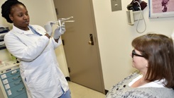 Ensuring an explanation with every exam… Cmdr. Teri Ryals, Naval Hospital Bremerton OB/GYN clinic department head and certified nurse midwife discusses the pap smear/pap test procedure provided at the Walk-In Cervical Cancer Screening Clinic held every Friday from 8 a.m. until noon, for those 21 and older in NHB’s OB/GYN clinic.  (Official Navy photo by Douglas H Stutz, NHB/NMRTC Bremerton public affairs officer)