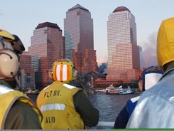 Flight Deck personnel of the USNS COMFORT watch as the “Floating Hospital” ship docks at Pier 92 in New York Harbor. 