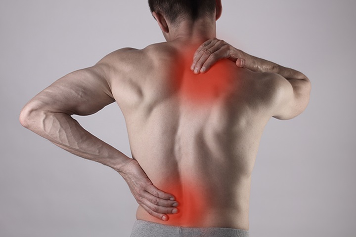 Image of Man holding his back.