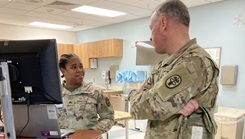 Army Medical Command East Command Sergeant Major Alexander Poutou, right, speaks with Sgt. Ashtin Josey in the Occupational Health clinic during a visit to Guthrie Ambulatory Health Care Clinic at Fort Drum, New York. (Photo: Ed Gulick)