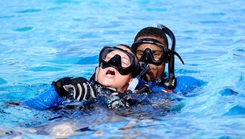 Navy Lt. Sharrod Green and Lt. Sean Hutchinson practice "ascending with a downed diver."