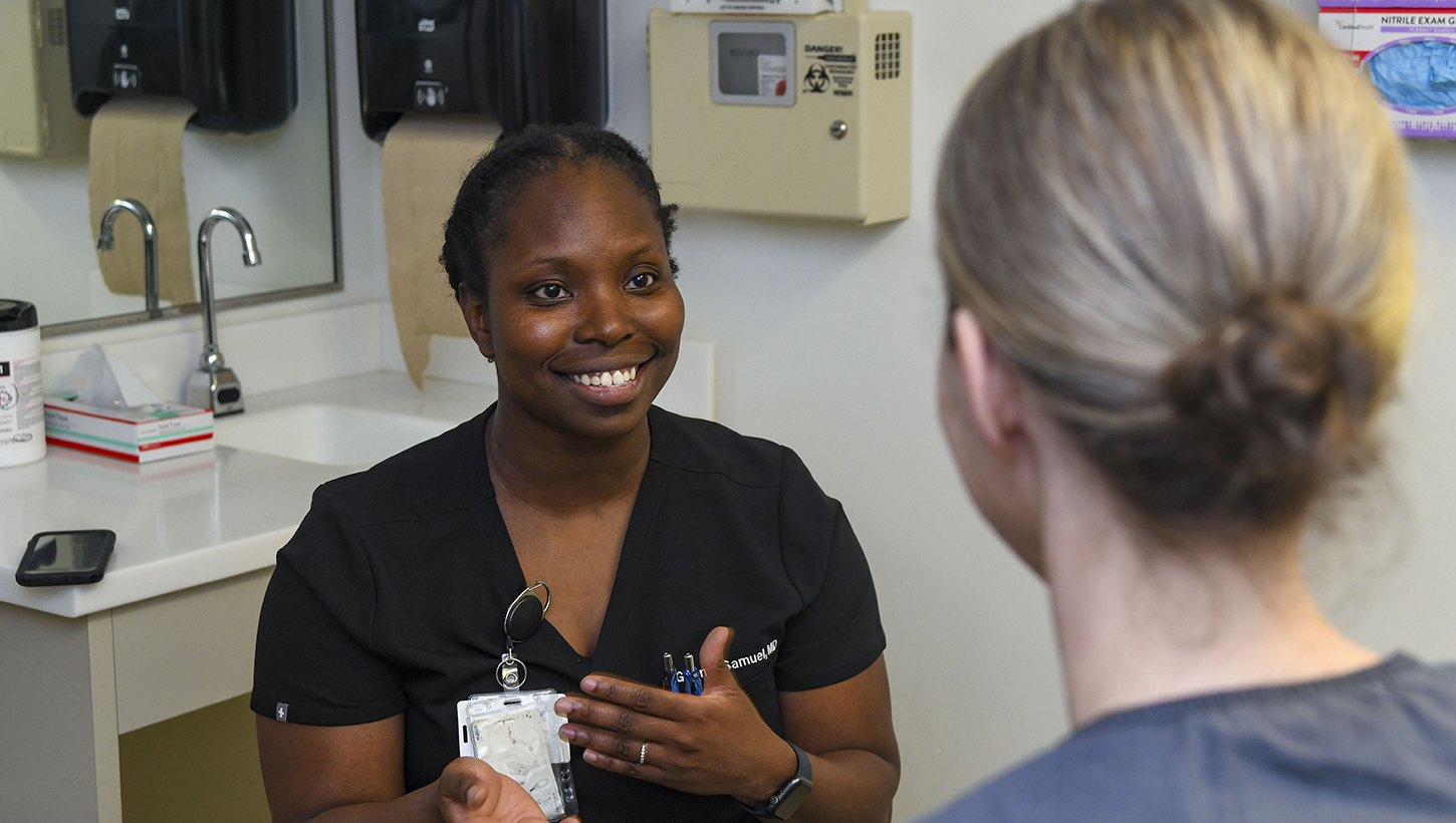 Dr. Joanne Gbenjo, Naval Medical Center Camp Lejeune's family medicine practitioner and chief virtual health informatics officer, uses a mobile device equipped with ambient listening during patient encounters
