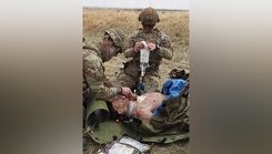 1st Lt. Brendan Killian, left, a 66H Medical-Surgical Nurse, and Staff Sgt. John Baek, a 68W Combat Medic, perform simulated tactical combat casualty care on a mannequin