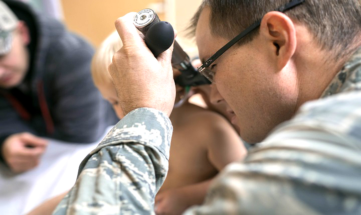 Air Force Capt. Michael Guindon, 374th Medical Group pediatrician, examines a young patient’s ear at Yokota Air Base, Japan. Odds are, your child will suffer an ear infection by age three. (U.S. Air Force photo by Senior Airman Delano Scott)