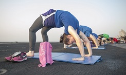 Navy Petty Officer 3rd Class Tara Paradiso participates in a sunrise yoga class on the flight deck aboard the aircraft carrier USS Theodore Roosevelt. If you’re thinking of adding exercise to your pain management plan, consider the following types: aerobic, strength, and flexibility. But make sure your exercise program is specifically tailored to your needs. Some exercises might be easier or more difficult to complete depending upon the type and location of your pain. (U.S. Navy photo by Mass Communication Specialist 2nd Class Chris Liaghat)