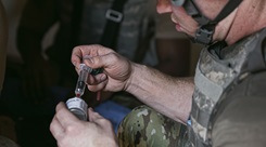 U.S. Air Force Capt. Hunter Brown, a registered nurse assigned to the 99th Medical Group, prepares pain medication for patient care during the 2025 Diamondback Medic Rodeo