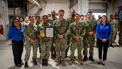 Sailors assigned to Naval Medical Center San Diego's Medical Logistics Warehouse pose for a group photo after receiving the Navy & Marine Corps Fisher House Volunteer of the Year award