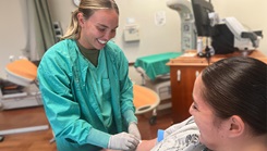 Cadet Jack Obunga, a nursing student from Campbell University, checks a patient’s vitals
