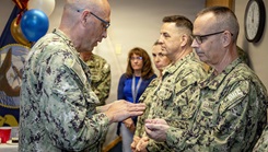 Capt. David Jeltma, Naval Medical Forces Atlantic (NMFL) Chaplain, blesses the hands of Rear Adm. Robert Hawkins, commander, NMFL, during a blessing of the hands ceremony