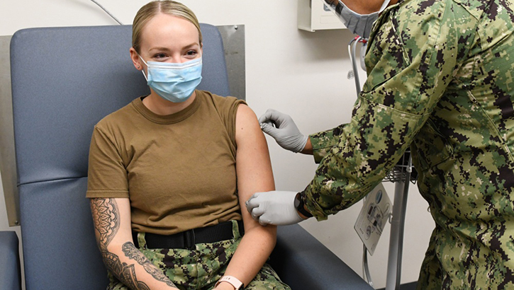 Image of Soldier giving another soldier a flu shot. Click to open a larger version of the image.