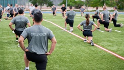 Guardians stretch before beginning the Delta 12 Summer Fitness Challenge Physical Training Field Day 