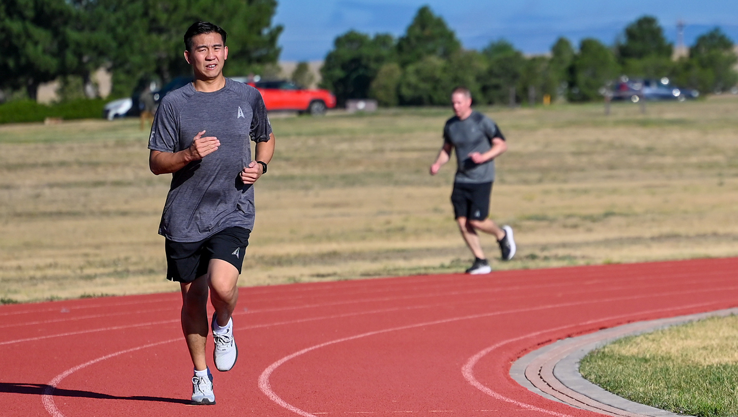 U.S. Space Force Guardians run around a track for physical training 