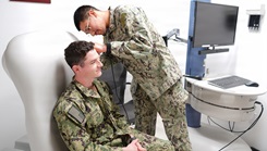 Hospital Corpsman 3rd Class Martin E. Romero Alvarez, a native of Dalton, Georgia, assigned to Navy Medicine Readiness and Training Command Rota, demonstrates a physical ear examination on a Sailor using a telehealth medical cart