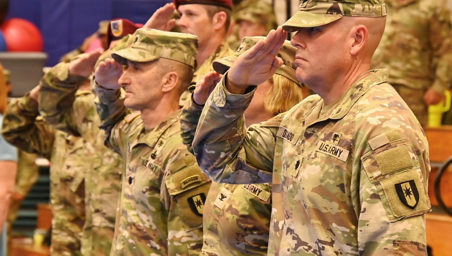 Lt. Col. Andrey V. Tsepelev, left, and Lt. Col. Steven P. Delgado render honors during the national anthem