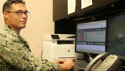 Hospital Corpsman 1st Class Jordan Cooper at his desk in Staff Education and Training