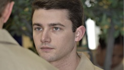 Hospital Corpsman 2nd Class Cade Crenshaw listens at attention