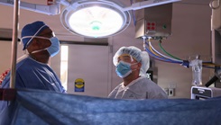 Cmdr. Harold Barnes (left), director of surgical services at Naval Hospital Twentynine Palms, and Sgt. 1st Class Norris R. Sayviseth, noncommissioned officer-in-charge of surgical services at Weed Army Community Hospital, perform surgery