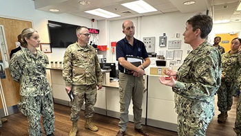 From left, Navy Capt. Heather Grote, chief medical officer of U.S. Naval Station Guantanamo Bay, Office of the Assistant Secretary of Defense for Health Affairs; Air Force Brig. Gen. John Andrus, then the Joint Staff Surgeon; and Dr. Stephen Ferrara, acting assistant secretary of defense for health affairs, listen as Navy Capt. Tammy Servies, director of U.S. Naval Hospital Guantanamo Bay, provides a tour of the emergency department. 
