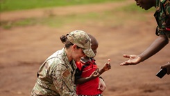 U.S. Air Force Lt. Col. Angela Ling, the lead medical readiness exercise planner for Justified Accord 26 with the 155th Medical Group, 155th Air Refueling Wing, Nebraska Air National Guard, introduces herself to a Tanzanian patient