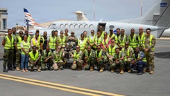 New Hampshire National Guard members, Cabo Verde Armed Forces Medical Unit members and medical professionals from the Ministry of Health pose for a group photo in front of a C-12 Huron multipurpose aircraft