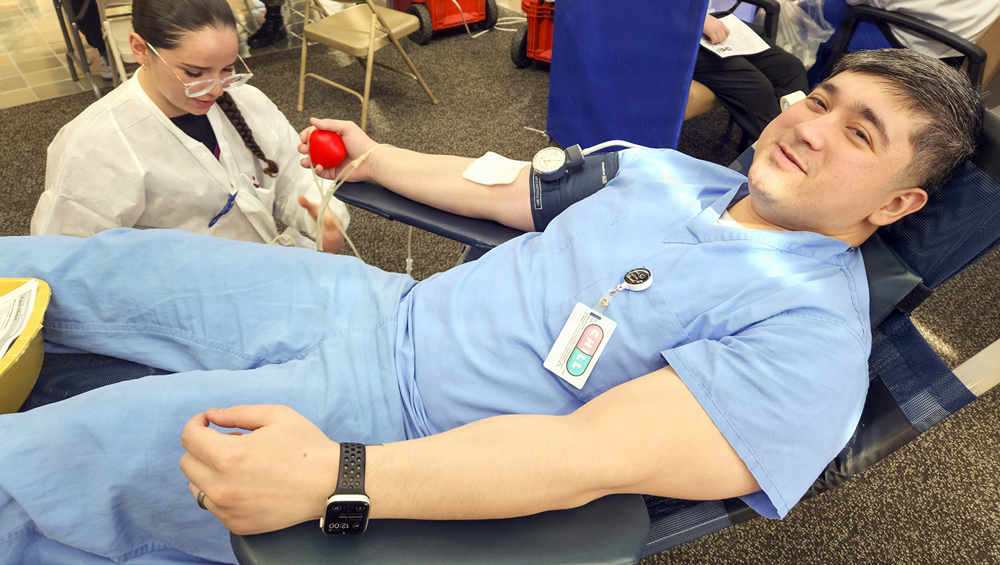 Hospital Corpsman 2nd Class Yong Cho, assigned to Navy Medicine Readiness and Training Command Bremerton, prepares to donate a unit of blood during a blood drive
