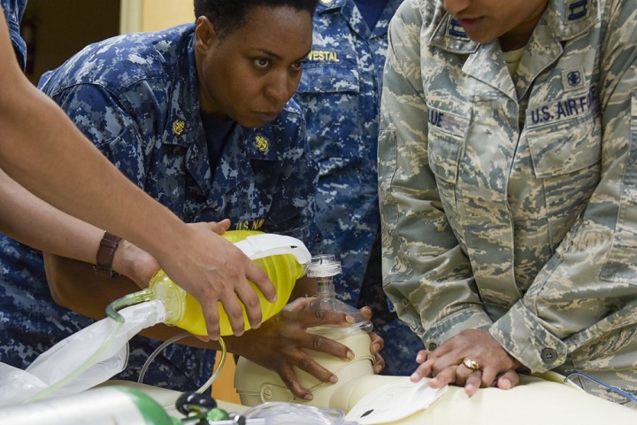 Navy Chief Petty Officer Wendy Wright, a hospital corpsman chief assigned to Expeditionary Medical Facility Great Lakes in Illinois, performs ventilation techniques on a practice mannequin while participating in a life support simulation in Savannah, Georgia. (U.S. Air Force photo by Staff Sgt. Caila Arahood)