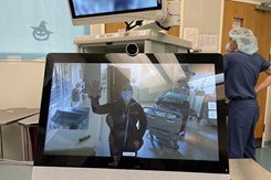 Photo by Christina Clarke, U.S. Naval Hospital Naples: The Urology department head at USNH Rota, Spain, waves to staff in USNH Naples, Italy during a virtual cystoscopy between both hospitals. This work must comply with the restrictions shown on https://www.dvidshub.net/about/copyright