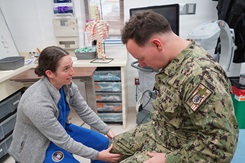 Photo by Lt Cmdr Alicia Sacks, U.S. Naval Hospital Rota: A fourth-year medical student at the Uniformed Services University of the Health Sciences performs a musculoskeletal examination. This work must comply with the restrictions shown on https://www.dvidshub.net/about/copyright