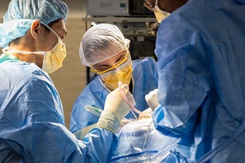 Photo by Ricardo Reyes-Guevara, Defense Health Agency: A surgical team removes a brain tumor at Walter Reed National Military Medical Center in Bethesda, MD. This work, must comply with the restrictions shown on https://www.dvidshub.net/about/copyright