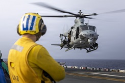Photo by Cpl. Matthew Williams, 26th Marine Expeditionary Unit: A U.S. Marine Corps UH-1Y Venom, assigned to Marine Light Attack Helicopter Squadron (HMLA) 167, 2nd Marine Aircraft Wing, hovers above Wasp-class amphibious assault ship USS Kearsarge (LHD 3). This work must comply with the restrictions shown on https://www.dvidshub.net/about/copyright