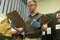 An investigator assesses files for potential study. 