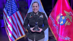 Maj. Erika B. Page holding her 2026 Hero of Military Medicine Award