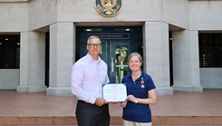 Lt. Cmdr. Dawn Weir, a microbiologist with Naval Medical Research Unit (NAMRU) INDO PACIFIC, receives the Meritorious Service Medal from Capt. Nicholas Martin, commanding officer of NAMRU INDO PACIFIC. NAMRU INDO PACIFIC