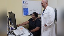 Dr. Daniel Singleton and Ms. Vanita Roberson discuss a patient encounter on Oct. 8, 2024, at Martin Army Community Hospital in Fort Moore, Georgia. MACH moved swiftly to take care of their patients by taking advantage of virtual care tools while Hurricane Helene threatened the community. (Photo by Jesse Hudon/Martin Army Community Hospital)