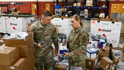 Army Reserve Sgt. Kurtice Sober, a combat medic of the Tampa, Florida-based 7222nd Medical Support Unit, and Capt. Kelly Sambrano, a perioperative nurse with the Southeast Medical Area Readiness Support Group of Nashville, Tennessee, review medical supplies for upcoming training missions 