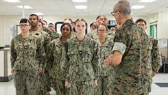U.S. Navy Rear Adm. Guido Valdez, medical officer of the Marine Corps, addresses U.S. Navy Hospital Corpsman 3rd Class Hailey Arp during a visit to Naval Branch Health Clinic Marine Corps Recruit Depot