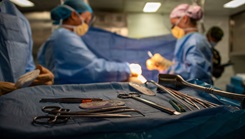 U.S. Army Capt. Danielle Patrick, assigned to Surgical Augmentation Detachment 105, and Hospitalman Lia Acostaguzman, assigned to Wasp-class amphibious assault ship USS Essex (LHD 2), perform a mock surgery during a mass casualty drill 