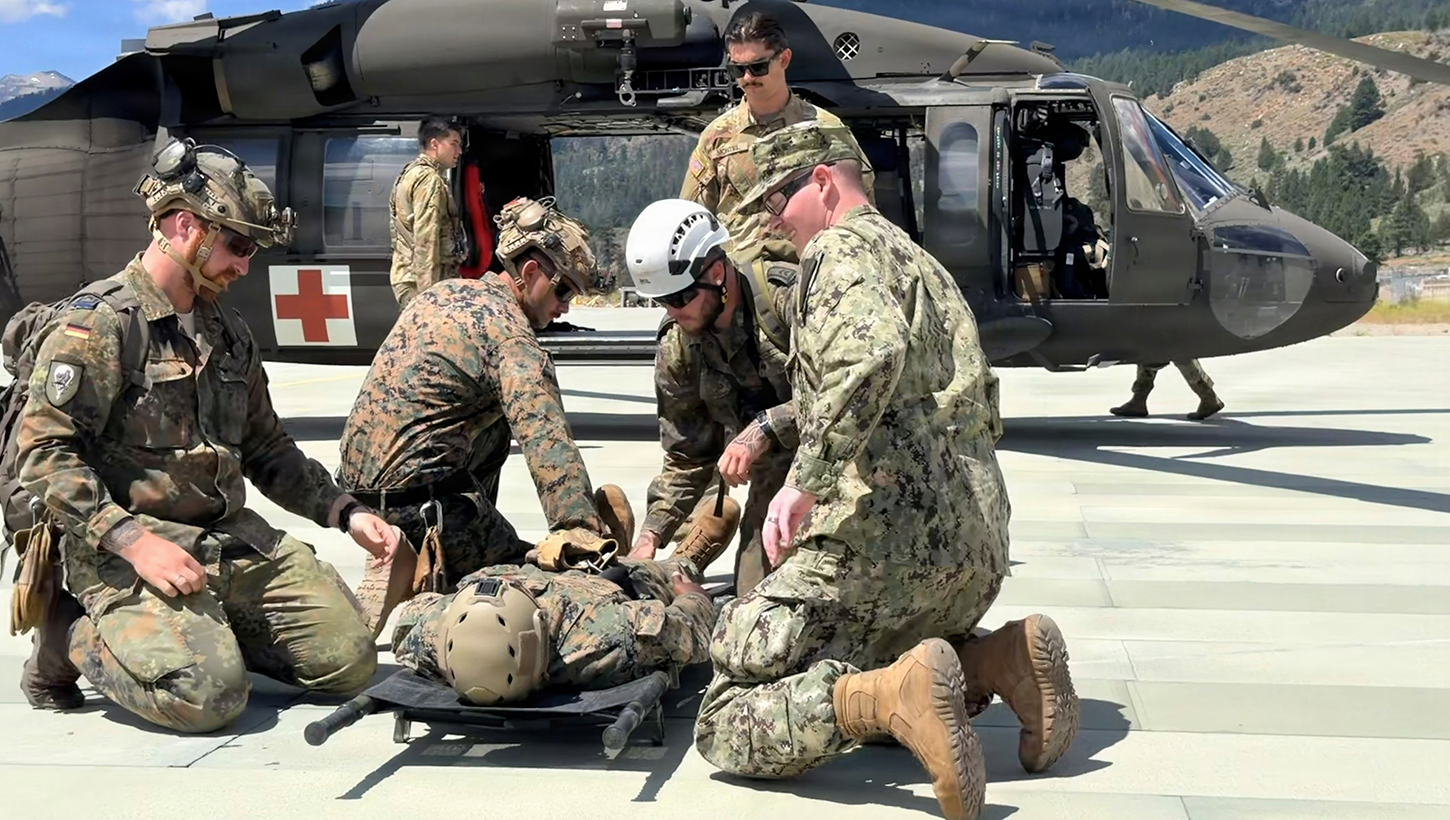 Chief Hospital Corpsman Noah Morrison, right, assists U.S. and allied service members during air medical evacuation familiarization training