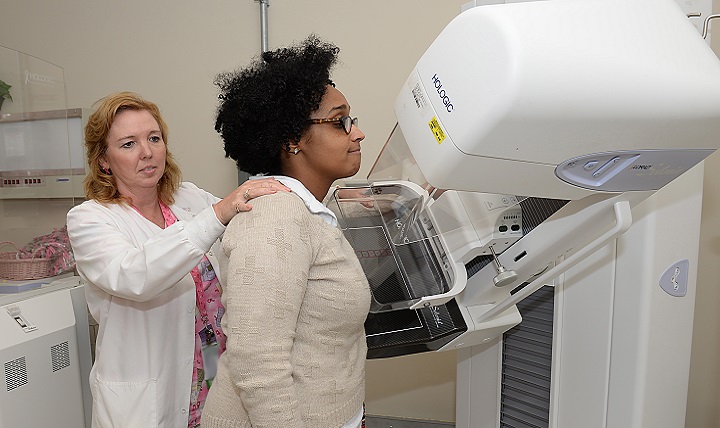 Wendy Elvis, lead mammography technician (left), demonstrates the use of a mammogram machine with Melissa McRae. Mammograms are recommended for women over the age of 40 and those whose family has a history of breast cancer. (U.S. Air Force photo by Staff Sgt. Teresa J. Cleveland)