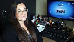 Paula Curielabreu posing for a picture at her desk