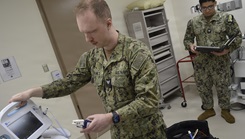 .Hospital Corpsman 3rd Class Jacob Holmes and Hospital Corpsman 2nd Class Renzo Marcelo, biomedical equipment technicians assigned to NMRTC Bremerton, troubleshoot equipment