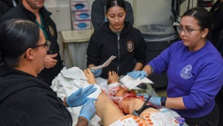 U.S. Navy sailors apply a tourniquet to a simulated open leg fracture in the emergency room during a trauma drill at Naval Medical Center Camp Lejeune