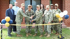Rear Adm. Robert Hawkins, commander, Naval MEdical Forces Atlantic (NMFL), director, Defense Health Network (DHN) Atlantic, and director of the Navy Nurse Corps, stands for a group photo with members of the Navy Nurse Corps 