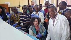 Dr. Sharon Juliano, a professor at the Uniformed Services University, and Professor Jean-Jacques Muyembe stand with African neuroscientists during a Teaching Tools Workshop