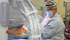 Orthopedic Surgeon Mark Gould, U.S. Navy retired captain, prepares for a hindfoot fusion surgery