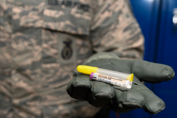 Air Force Staff Sgt. Matthew Pick, with the 66th Security Forces Squadron, holds a nasal applicator and naloxone medication vial at Hanscom Air Force Base, Massachusetts. Naloxone is one of several medications designed to temporarily reverse the effects of an opioid overdose. Hanscom was the first Air Force installation to issue the drug to law enforcement personnel under permission of the base commander. (U.S. Air Force photo by Mark Herlihy)
